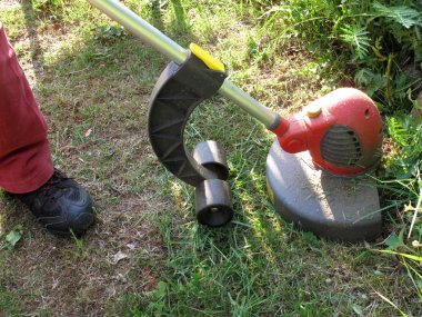 Person using grass strimmer clipart