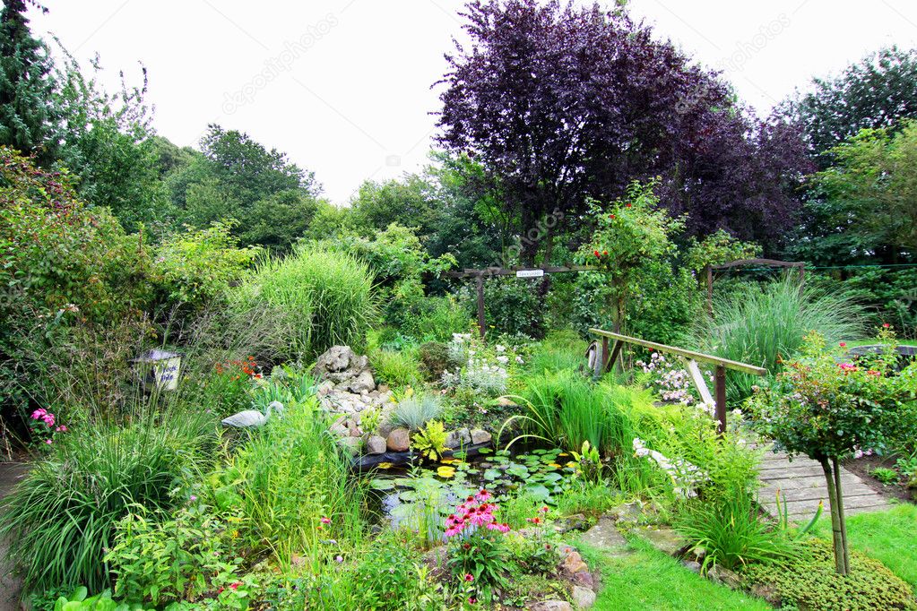 Landscaped garden with bridge over pond