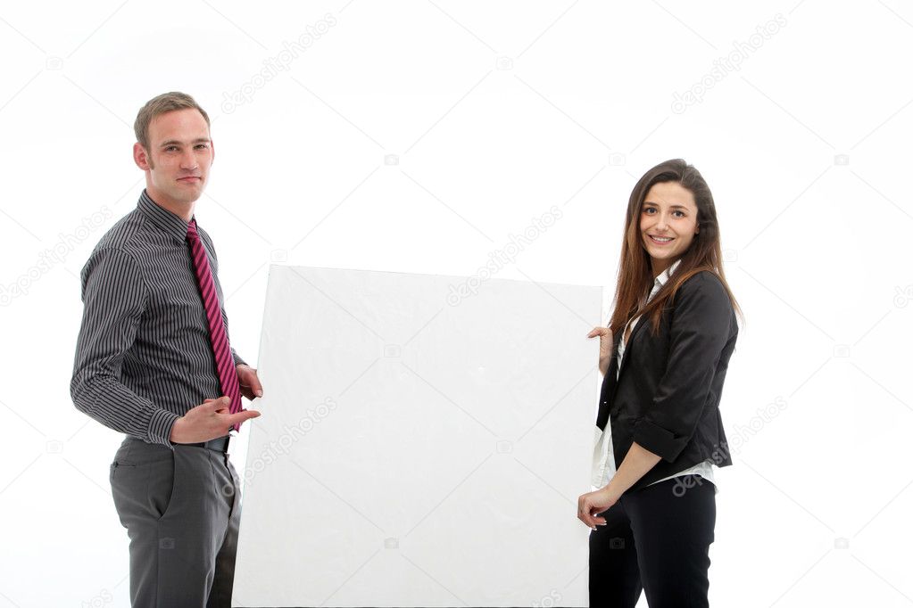Young man and woman holding a large blank poster