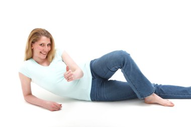 Pretty smiling blonde girl reclining on the floor