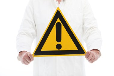 Man holding a caution sign with exclamation point clipart