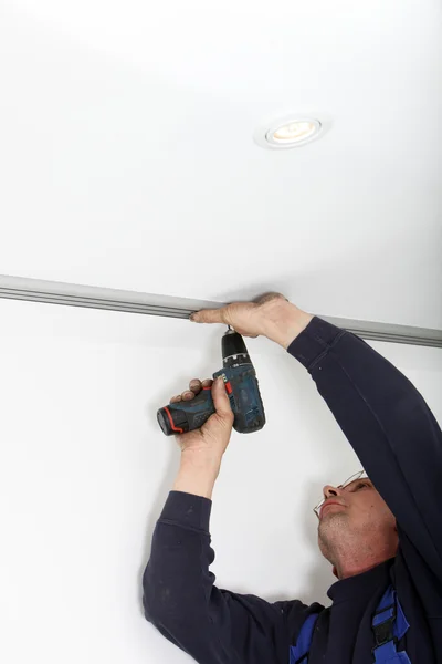 Man Fitting Metal Track To Ceiling — Stock Photo, Image