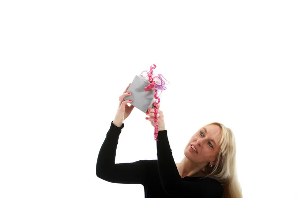 Attrative woman holding a small gift — Stock Photo, Image