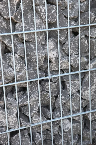 Rocce grigie in una gabbia — Foto Stock