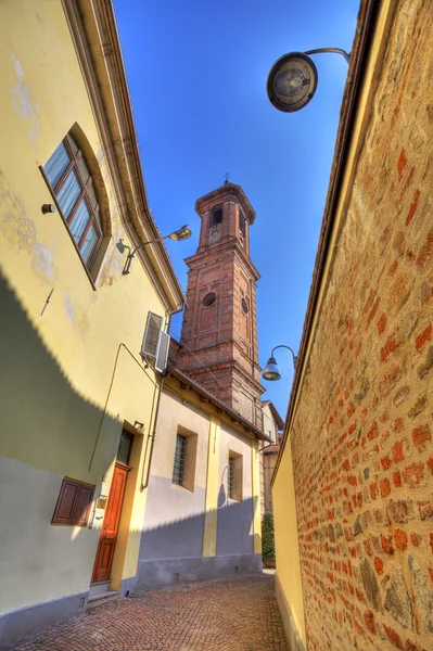 Old street and church tower in Alba. — Stock Photo, Image