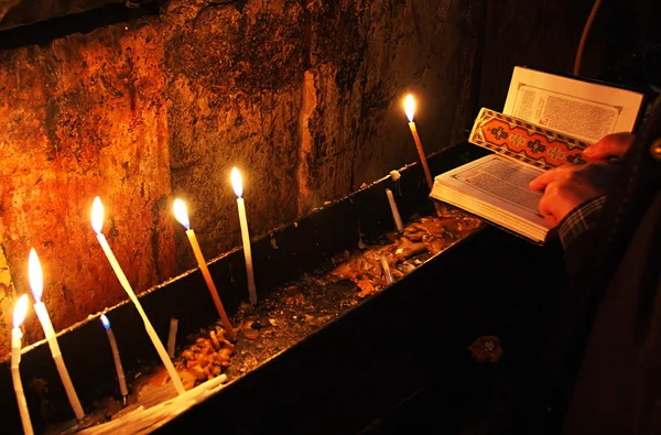 stock image Prayer with Holy Bible and candles in the church.