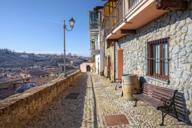 Narrow street and old house. La Morra, Northern Italy. clipart