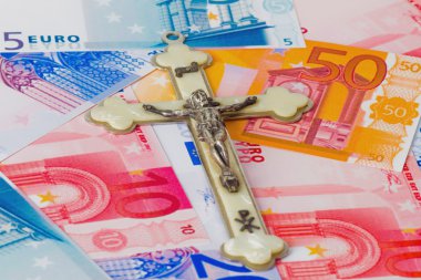 Crucifix on euro banknotes clipart