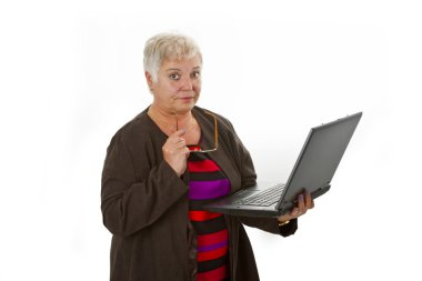 Skeptic female senior with laptop clipart