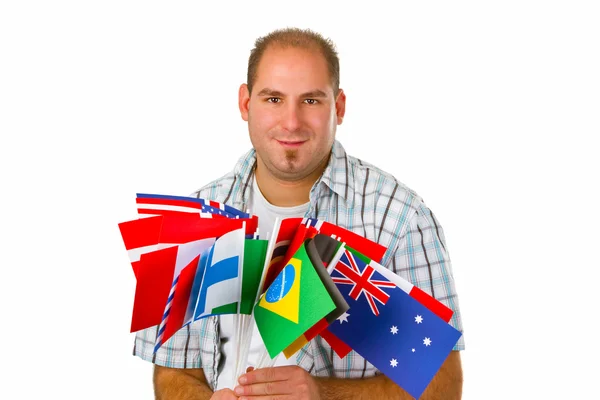 Mladý muž s mezinárodními vlajkami — Stock fotografie