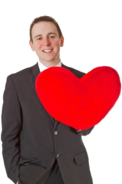 Przystojny mężczyzna z poduszką w kształcie serca czerwone — Zdjęcie stockowe