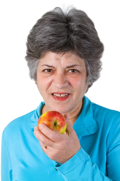 Female senior eating a fresh apple — Stock Photo, Image