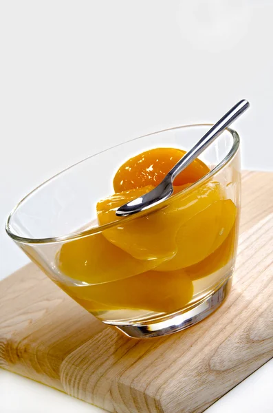 Peach half in a glass bowl — Stock Photo, Image