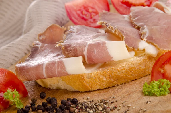 Ham sandwich on a wooden board — Stock Photo, Image