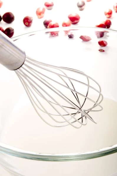 Milk in a glass bowl with a whisk — Stock Photo, Image