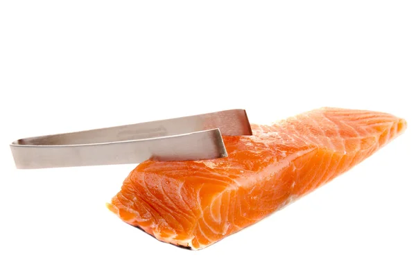 Salmon filet and a pliers — Stock Photo, Image