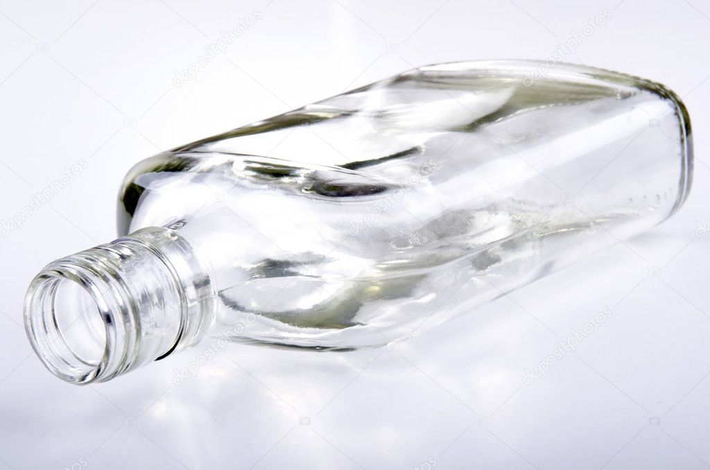 Empty small bottle lying on a light background