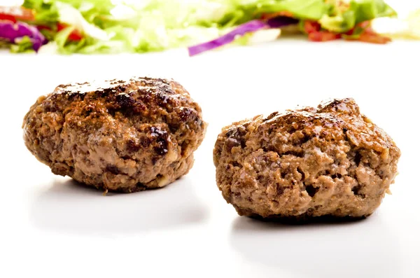Homemade meat balls and salad in the background — Stock Photo, Image