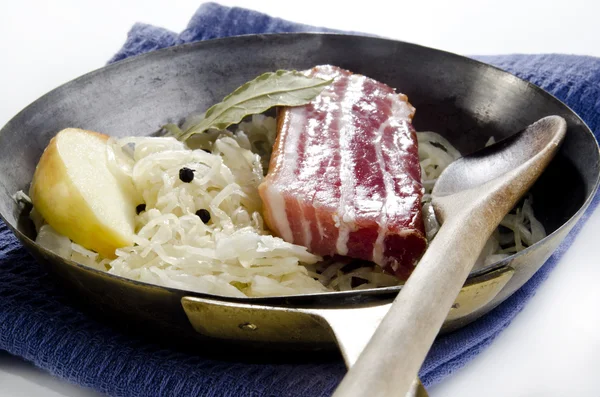 Sauerkraut with bacon and apple in a pan — Stock Photo, Image
