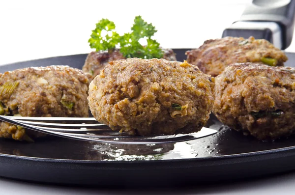 Freshly fried meat balls lying on a pan — Stockfoto