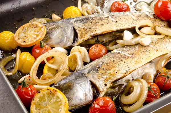 Trout fillet in a pan with tomato and onion — Stock Photo, Image