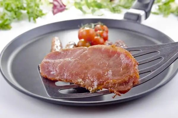 Slice of bacon on a spatula — Stock Photo, Image