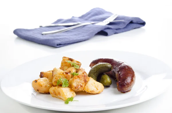 Golden brown fried potatoes with grilled sausage — Stock Photo, Image