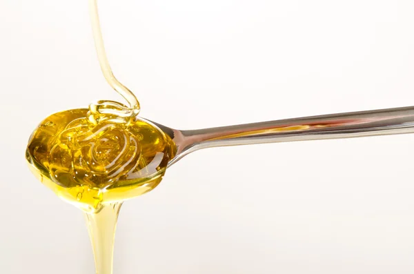 Blossom honey on a small spoon — Stock Photo, Image