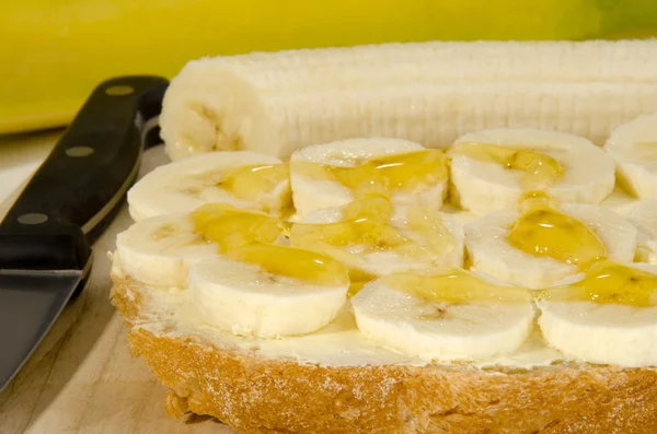 stock image Slice bread with banana slices and honey