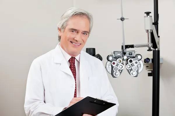 Lächelnder Optiker mit Notizblock — Stockfoto