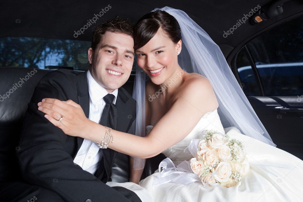Happy Wedding Couple in Limo