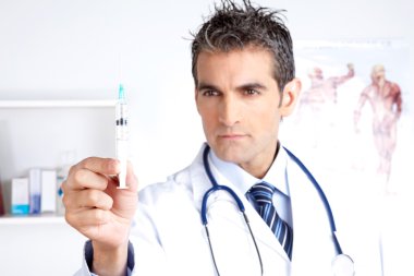 Male Doctor Looking at Syringe clipart