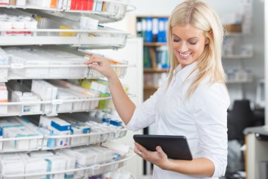 Female Chemist Standing in Pharmacy Drugstore clipart