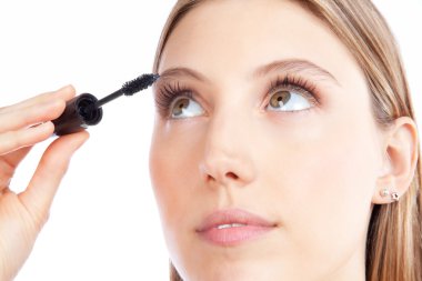 Woman Applying Mascara clipart