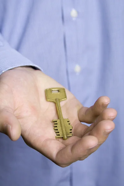 House key in palm — Stock Photo, Image