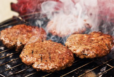 Burger patties on a grill clipart