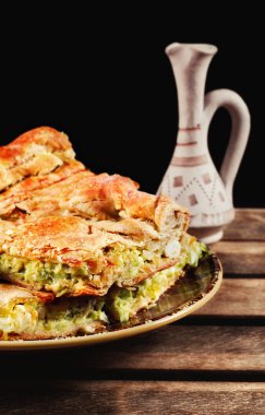 Traditional homemade balkan leek and cheese pie served with rakija clipart