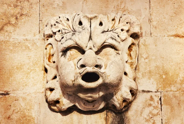 Sculpted stone mask figure on ancient fountain on the side of Church of Saint Blaise (St.Vlaha) Dubrovnik — Stock Photo, Image