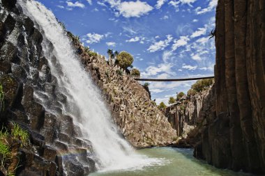 Waterfall at basaltic prism canyon at Hidalgo, Mexico clipart