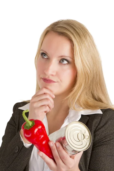 Femme pensive avec des légumes frais et en conserve — Photo