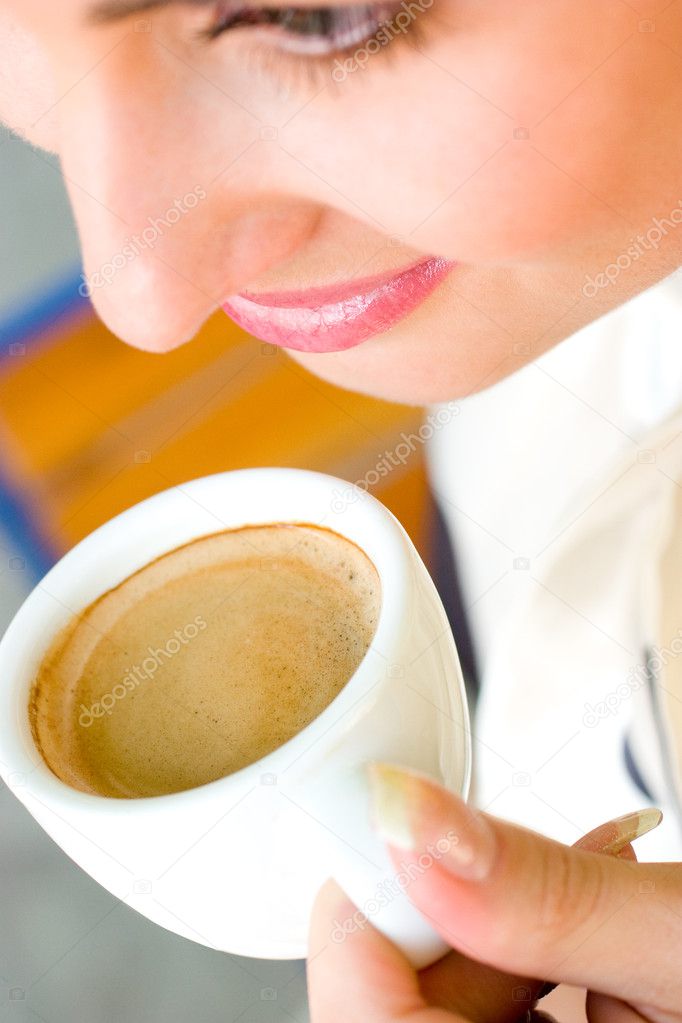 Beautiful smiling woman drinking coffee