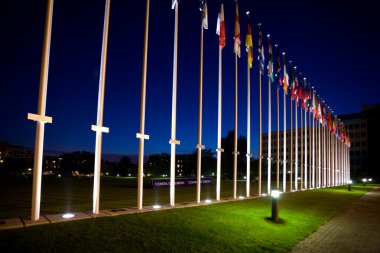 International flags next to european council building in Strasbo clipart