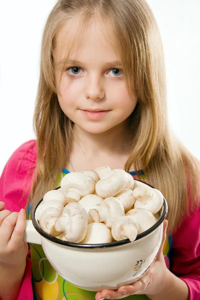 Pretty little girl holding metal pot with mushrooms — Stock Photo, Image