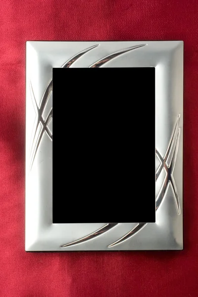 Silver photo frame over red silk — Stock Photo, Image