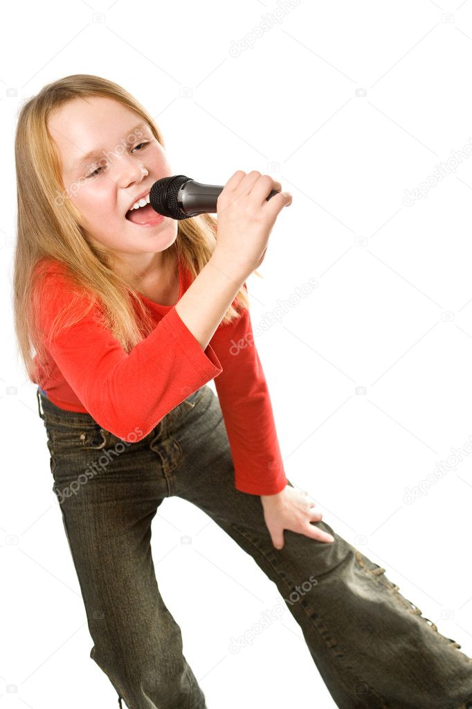 Pretty little girl singing in microphone isolated over white