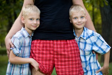 Happy dad with twin boys clipart