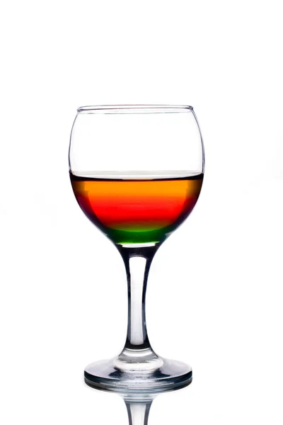 Wineglass with multicolored cocktail isolated on white — Stock Photo, Image