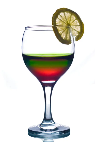 Rainbow colored drink with lemon — Stock Photo, Image