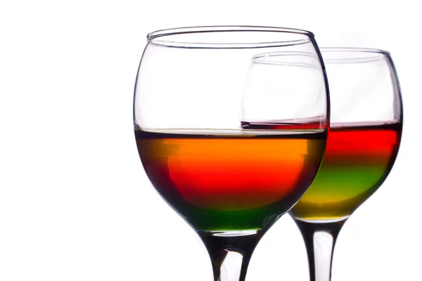 Wineglasses filled with multicolored cocktail — Stock Photo, Image