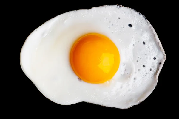 孤立在黑色的煎的鸡蛋 — 图库照片